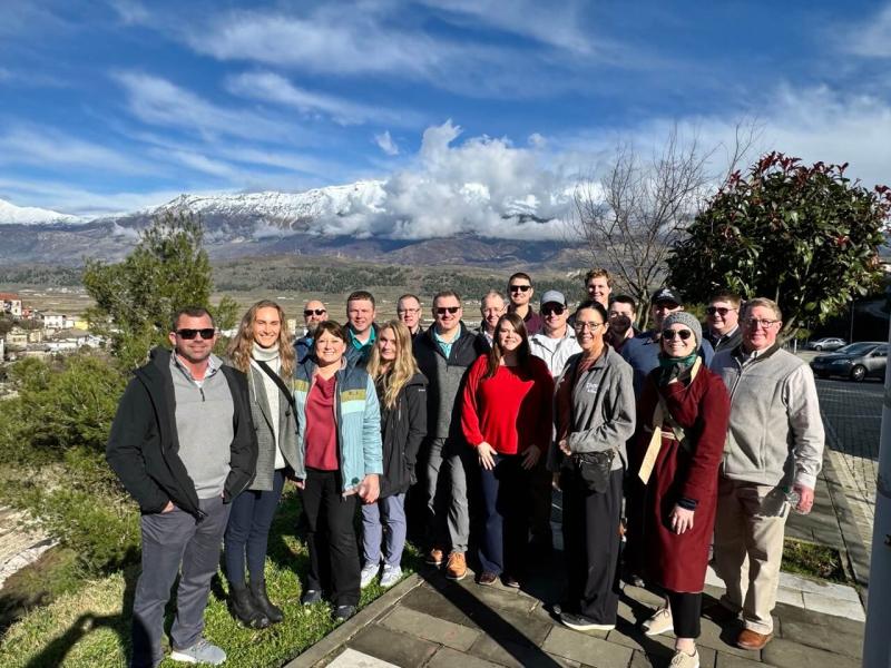 The class poses for a picture after the castle and museum tour. In the background, Gjirokastra can just barely be seen but note the snow-capped mountains! 