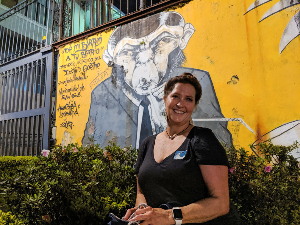 Jenny Penny in front of political mural