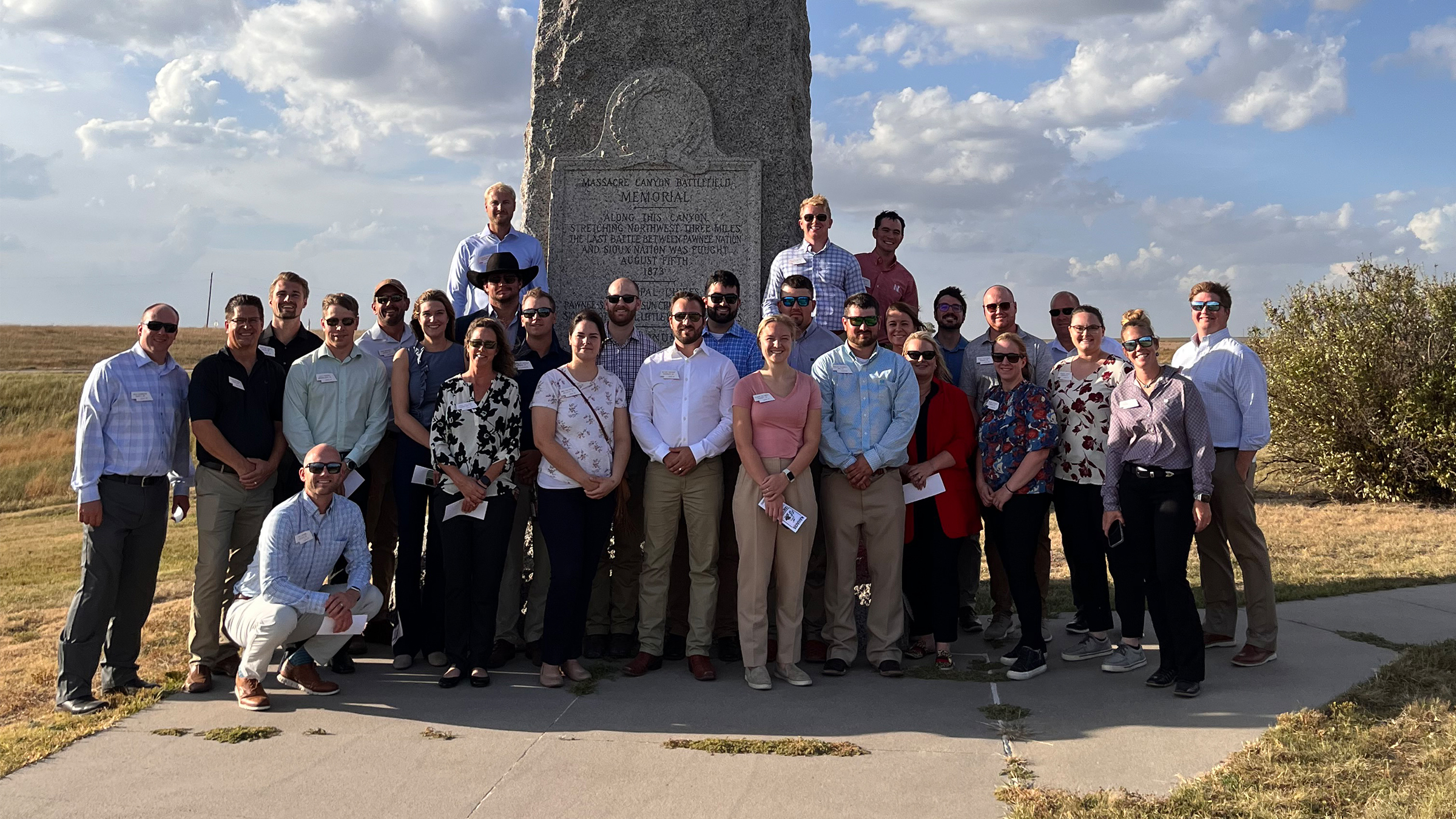 Nebraska LEAD 42 Fellows posing for a group photo in front of the Massacre Canyon Battlefield Memorial.