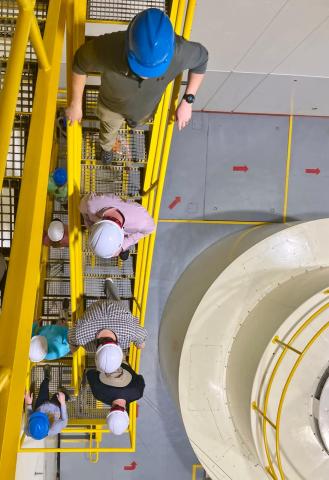 Going deep: Fellows descend underground to view the facility’s turbine system.