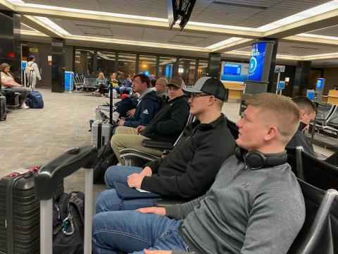 Eric Coufal, Logan Sheets, Dylan Haas, and Blake Wohlers anticipate the boarding call for DFW to San Juan, Costa Rica. 