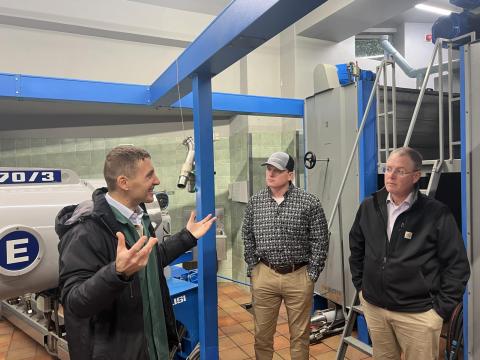 Class members Caleb Ayers and Joe Ruskamp listen as one of the Bartolini family members describe the olive oil pressing process. 