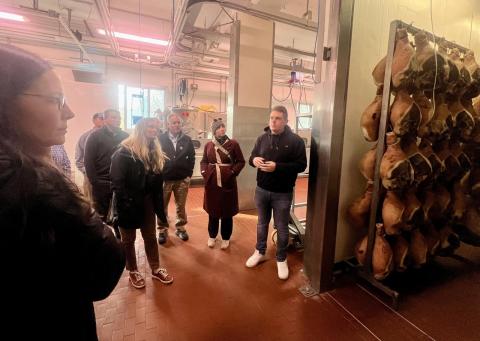 A group photo in a ham factory.