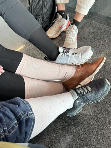 Fellows show off their compression socks prior to departure for their long flights. 