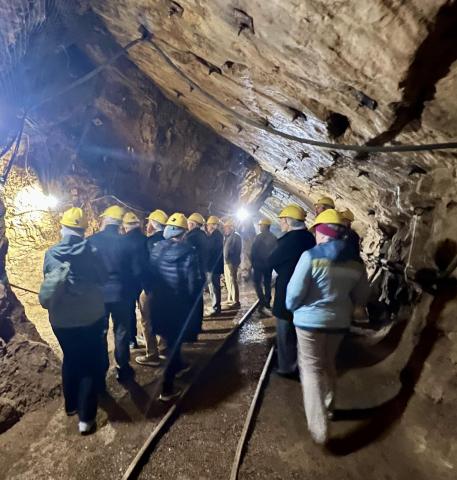 A group gathered in a working mine.